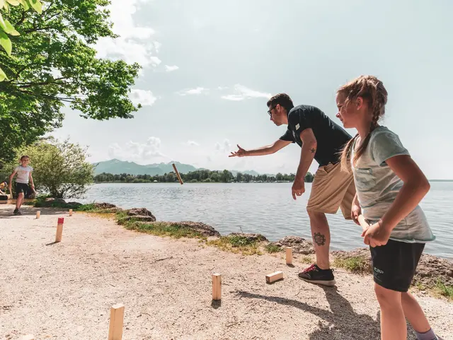 Familie spielt Wikingerschach am Chiemsee in Übersee im Sommer